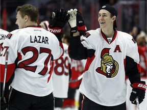 Curtis Lazar and Kyle Turris hi-five.