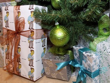 Decorative packages under a Christmas tree, located outside the mayor's boardroom during his holiday reception held Wednesday, December 16, 2015,  included a box wrapped by Ottawa artist Andrew King with his cartoon version of Mayor Jim Watson, inspired by The Simpsons. (Caroline Phillips / Ottawa Citizen)