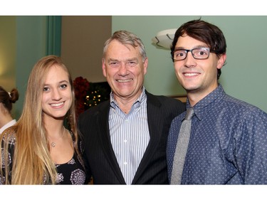 Dental student Elizabeth Ross was seen chatting with Dick Brown, president and CEO of Ottawa Tourism, and her boyfriend, Will Bulmer, special assistant to Mayor Jim Watson and volunteer bartender at a holiday reception the mayor hosted in his boardroom at City Hall on Wednesday, December 16, 2015. (Caroline Phillips / Ottawa Citizen)
