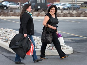 Diane Strand (R) and Kala Smith, both in Ottawa on business from the Yukon, enjoy the balmy weather while on a shopping trip to the Trainyards.