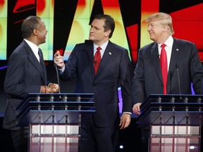 Republican presidential candidates, from left, Ben Carson, Ted Cruz and Donald Trump speak together during a break at the CNN Republican presidential debate in Las Vegas.