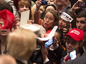 Supporters clamour for Republican presidential candidate Donald Trump's autograph during a campaign stop in Hilton Head Island, S.C., Wednesday, Dec. 30, 2015.