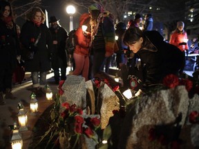 Dozens attended the candlelight vigil marking the anniversary of the Montreal Massacre at the Women's Monument in Minto Park on Sunday, Dec. 6, 2015.