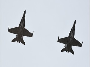 This file photo shows two CF-18s conducting a flypast.
