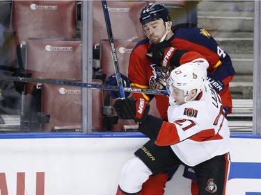 Ottawa Senators right wing Curtis Lazar (27) slams Florida Panthers defenseman Erik Gudbranson (44) into the boards during the first period.