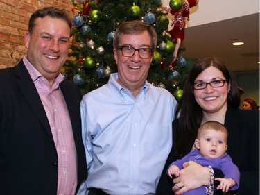 From left, David Gourlay, president of the Ottawa Champions Baseball Club, with Mayor Jim Watson and Gourlay's wife, Danielle McGee, who works for the mayor, and the couple's three-month-old daughter, Sophia, at a holiday reception the mayor hosted at his office.