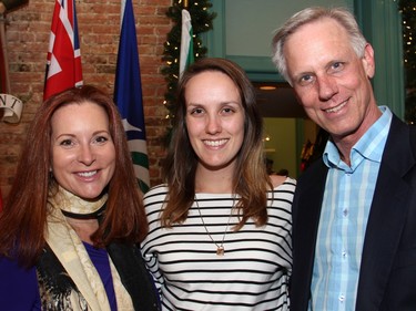 From left, former CTV Ottawa weekend news anchor Kimothy Walker, now managing partner at Ottawa Media Group, with Alexandra Joy and her dad, Greg Joy, who won a silver medal in high jump at the 1976 Olympics, at a holiday party hosted by Mayor Jim Watson at the Mayor's Boardroom at City Hall on Wednesday, December 16, 2015.