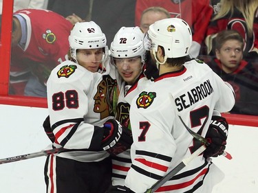 Chicago Blackhawks' Artemi Panarin (72) celebrates his goal against the Ottawa Senators with teammates Patrick Kane (88) and Brent Seabrook (7) during second period NHL action.