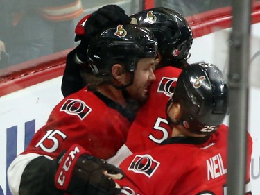 Ottawa Senators' Zack Smith (15) celebrates his goal against the Columbus Blue Jackets with teammates Chris Neil (25) and Cody Ceci (5) during first period NHL action.