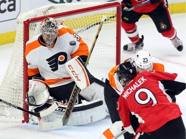 Philadelphia Flyers' goalie Steve Mason (35) makes a chest save during first period NHL action.
