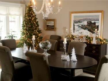 In the dining room, crystal provides a glittering accent to the dining set Andy Gross inherited from his paternal grandparents. The hutch and buffet paired with it were found at the old Stittsville Flea Market about 30 years ago. An artificial tree in the corner has no ornaments, just lights, garland and ribbon. ‘I wanted something simple,’ Nora Gross says.