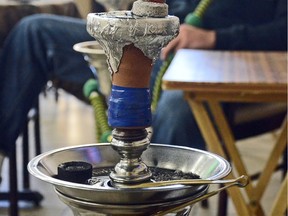 A hookah smoking apparatus is shown loaded up with a 'grape mint' shisha.