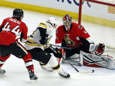 Boston Bruins' Frank Vatrano (72) shoots on Ottawa Senators goaltender Craig Anderson (41) as Jean-Gabriel Pageau (44) defends during first period NHL hockey action against the in Ottawa on Sunday, December 27, 2015.