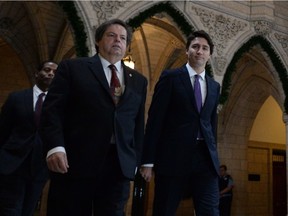 Prime Minister Justin Trudeau arrives at a caucus meeting with Liberal MP Mauril Belanger on Parliament Hill in Ottawa on Wednesday, Dec. 2, 2015.