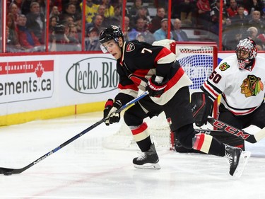 Kyle Turris of the Ottawa Senators about to make the pass to Mike Hoffman for his goal against  Corey Crawford and the Chicago Blackhawks during first period action.