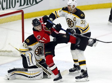 Ottawa Senators' Kyle Turris (7) is checked by Boston Bruins' Zdeno Chara (33) in front of the Boston net during first period NHL hockey action in Ottawa on Sunday, December 27, 2015.