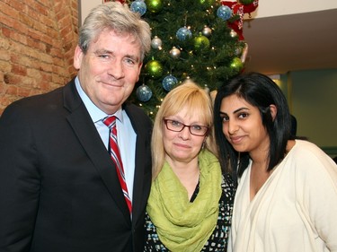 Liberal Ottawa South MPP John Fraser with his wife, Linda, and his executive assistant, Rahmat Kassam, at a holiday party hosted by Mayor Jim Watson at the Mayor's Boardroom at City Hall on Wednesday, December 16, 2015. (Caroline Phillips / Ottawa Citizen)