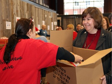 Liberal Ottawa West-Nepean MP Anita Vandenbeld was among the volunteers helping to pack 700 food hampers on Friday, December 18, 2015, at the Horticulture Building at Lansdowne for the Caring and Sharing Exchange and its annual Christmas Exchange Program. (Caroline Phillips / Ottawa Citizen)
