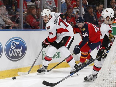 Ottawa Senators defenseman Mark Borowiecki (74) and Florida Panthers forward Logan Shaw (48) vie for control of the puck behind the net during the first period.