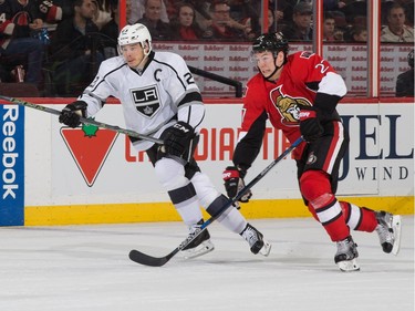 Dustin Brown #23 of the Los Angeles Kings races on the forecheck against Curtis Lazar #27 of the Ottawa Senators.