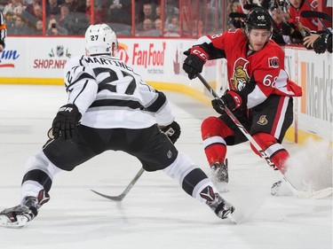 Mike Hoffman #68 of the Ottawa Senators stickhandles the puck at the blue line against Alec Martinez #27 of the Los Angeles Kings.