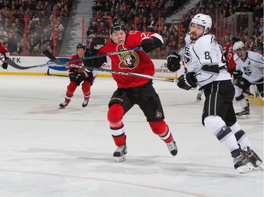 Curtis Lazar #27 of the Ottawa Senators skates against Drew Doughty #8 of the Los Angeles Kings on the forecheck.