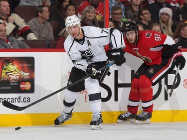 Jeff Carter #77 of the Los Angeles Kings drives to the net with the puck against Mika Zibanejad #93 of the Ottawa Senators.