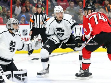 Mark Borowiecki of the Ottawa Senators battles against Brayden McNabb and Jonathan Quick, left, of the Los Angeles Kings during first period action.
