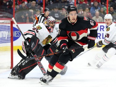 Mark Stone, left, of the Ottawa Senators against Corey Crawford, left, and Jonathan Toews of the Chicago Blackhawks during first period action.