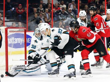 Mark Stone of the Ottawa Senators battles for the puck against Joonas Donskoi of the San Jose Sharks during the first period.