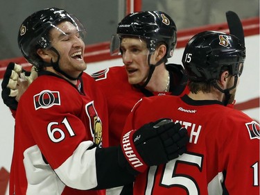 Ottawa Senators' Mark Stone (61) celebrates his goal with teammates Kyle Turris (7) and Zack Smith (15) during first period NHL hockey action against the Boston Bruins in Ottawa on Sunday, December 27, 2015.