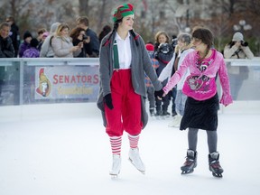 Sylvie Lahaie, left, skates with Amber Lapointe on the Sens Rink of Dreams at the Mayor's 15th Annual Christmas Celebration Saturday.