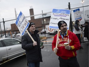 Correctional officers gather in front of the main entrance of Ottawa Carleton Detention Centre early December 10 2015.