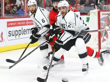 Mika Zibanejad of the Ottawa Senators battles against Jake Muzzin, left, and Alec Martinez of the Los Angeles Kings during first period action.