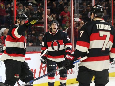 Mike Hoffman, centre, of the Ottawa Senators celebrates his goal with Bobby Ryan, left, and Kyle Turris during first period action.