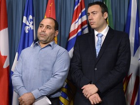 Mohamed Harkat (left), who was arrested and detained under a secret trial Security Certificate, stands with lawyer Leo Russomano during a press conference to mark the 13th anniversary of his detention and International Human Right's Day on Parliament Hill in Ottawa on Thursday, Dec. 10, 2015.