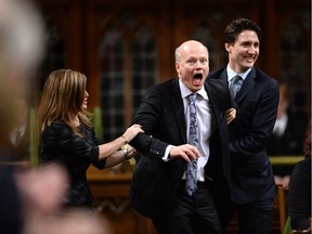 Newly-elected Speaker of the House Geoff Regan, centre, jokingly resists as he's escorted to the Speaker's chair by Conservative interim leader Rona Ambrose, left, and Prime Minister Justin Trudeau in the House of Commons on Parliament Hill in Ottawa on Thursday, Dec. 3, 2015.