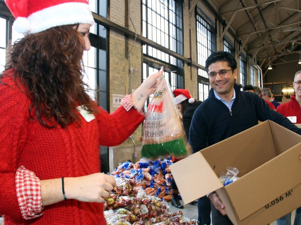 Around Town: Big names help pack 700 Christmas food hampers for the
needy