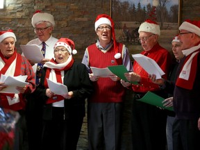 Ottawa mayor Jim Watson (centre) and the last mayors of the pre-amalgamation cities, belted out Christmas carols at Orchard View Living Centre in Manotick Tuesday as part of the annual "Old Grey Mayors" event.   His fellow carollers included (from left): Glenn Brooks, former mayor of Rideau township, Doug Thompson, former mayor of Osgoode township, Mary Pitt, former mayor of Nepean, Mayor Watson, Guy Cousineau, former Vanier mayor, city councillor Scott Moffatt, and Allan Higdon, former mayor of Ottawa.  (Julie Oliver / Ottawa Citizen)