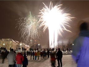 People watch as fireworks go off at 10 p.m. at Ben Franklin Place in 2013.