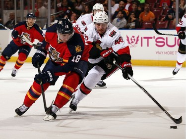 Reilly Smith #18 of the Florida Panthers tangles with Patrick Wiercioch #46 of the Ottawa Senators.