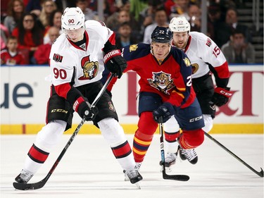 Alex Chiasson #90 of the Ottawa Senators controls the puck against Shawn Thornton #22 of the Florida Panthers.