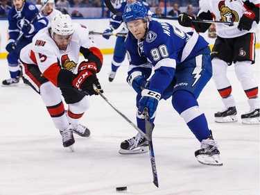 Vladislav Namestnikov #90 of the Tampa Bay Lightning controls the puck against Cody Ceci #5 of the Ottawa Senators during the first period.