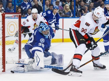 Goalie Ben Bishop #30 of the Tampa Bay Lightning makes a save against Alex Chiasson #90 of the Ottawa Senators during second period.