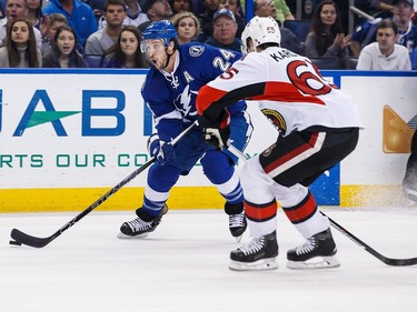 Ryan Callahan #24 of the Tampa Bay Lightning shoots the puck against Erik Karlsson #65 of the Ottawa Senators during the first period.