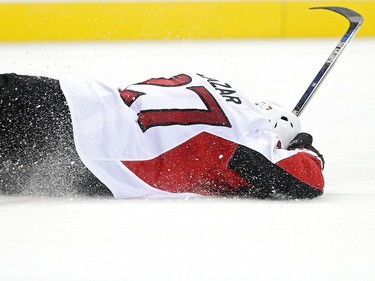 Curtis Lazar #27 of the Ottawa Senators lays on the ice after taking a hit in the third period.