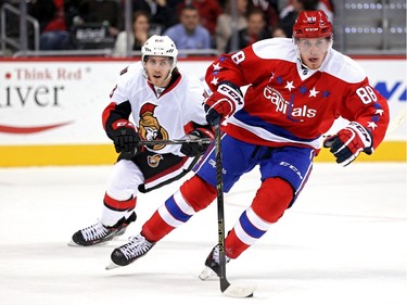Nate Schmidt #88 of the Washington Capitals skates past Mike Hoffman #68 of the Ottawa Senators in the first period.