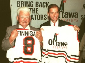 In 1989, original Senators player Frank Finnigan and Bruce Firestone display a prototype Ottawa Senators jersey.