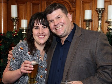 Paul Meek, president of Kichesippi Beer, with  Sheena Sherwood, who works for him, at a holiday reception hosted by Mayor Jim Watson in his boardroom at City Hall on Wednesday, December 16, 2015. (Caroline Phillips / Ottawa Citizen)