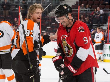 Milan Michalek #9 of the Ottawa Senators shares a laugh with Jakub Voracek #93 of the Philadelphia Flyers before the game. Halfway through Michalek suffered a broken finger.